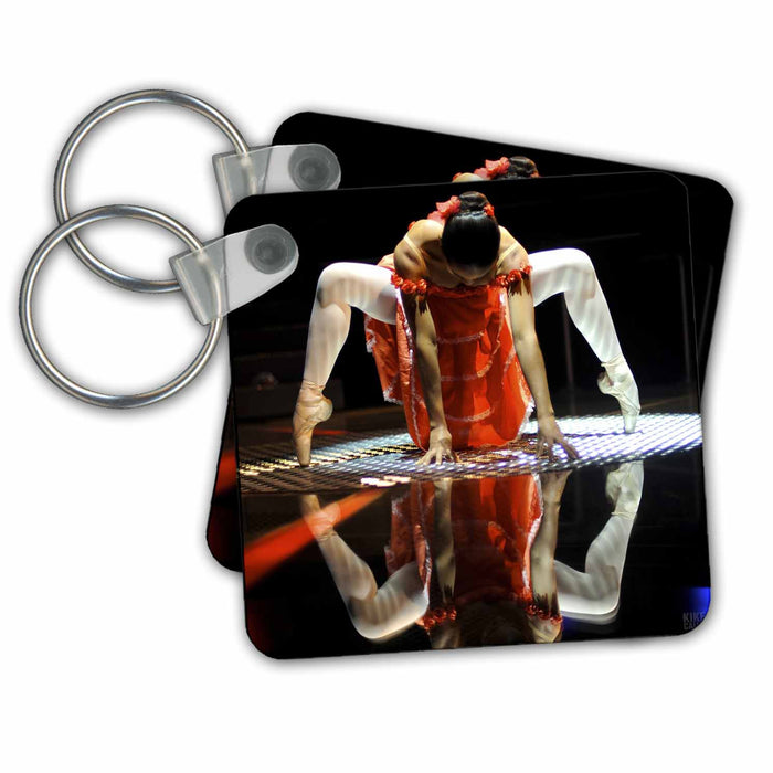 Key Chain - Ballerina dressed up with a Spanish style orange dress, performing on a silver surface Dance